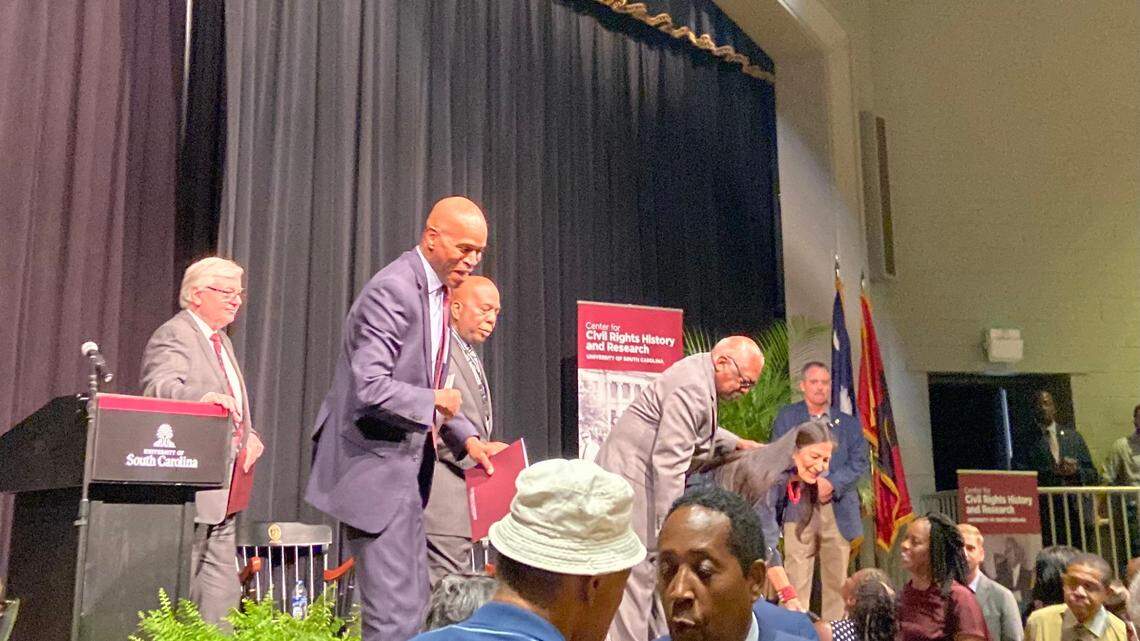 Professor Bobby Donaldson, U.S. Rep. James Clyburn and Secretary of the Interior Deb Haaland greet community members at Booker T. Washington Auditorium.