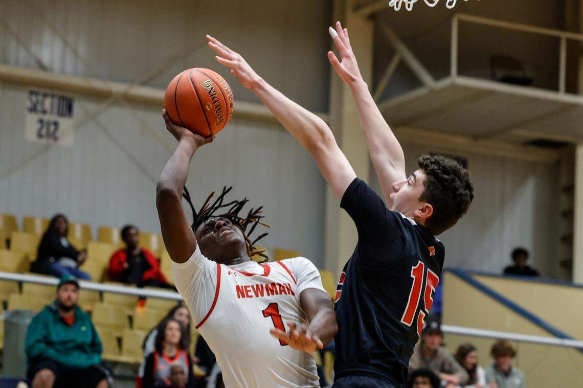 Cardinal Newman’s Amarii King (1) shoots as Augusta Christian’s Chuck Schwartz (15) defends during the first half of action in the Class 4A SC Independent Schools Association championship at the Sumter Civic Center on Friday, Feb. 23, 2024