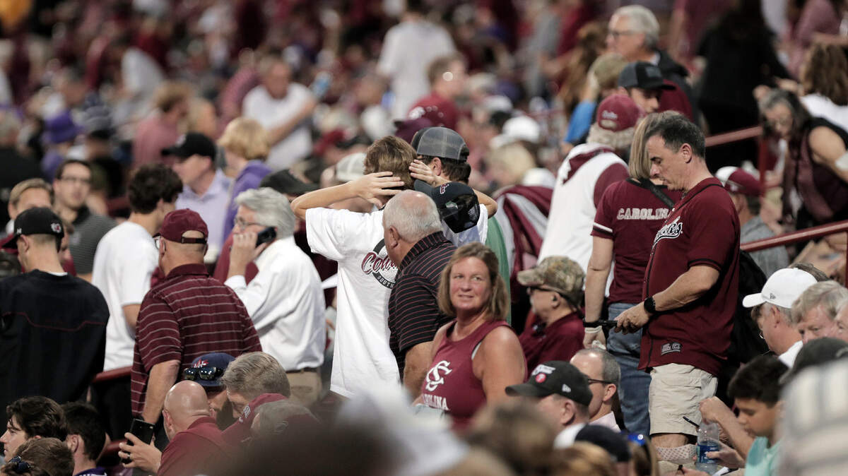 Fans leave their seats at Founders Park after lightning was detected in the area Thursday night.