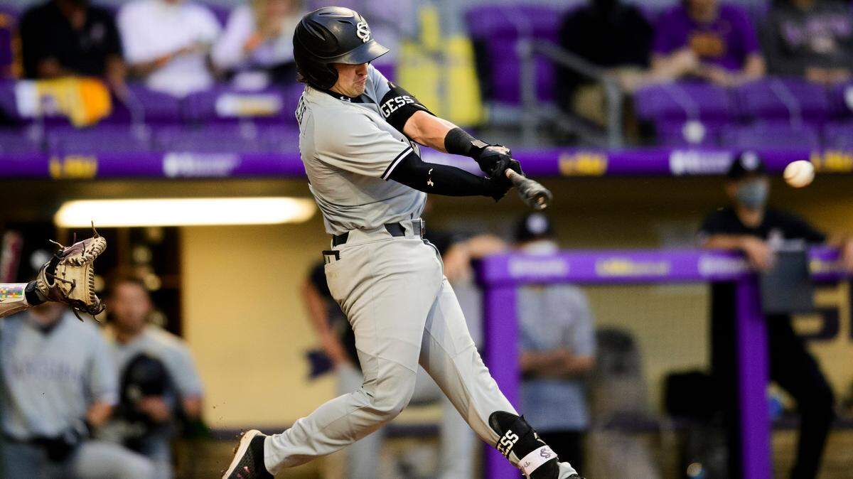 South Carolina Gamecocks baseball player Colin Burgess swings at a pitch against LSU on Thursday, April 15.