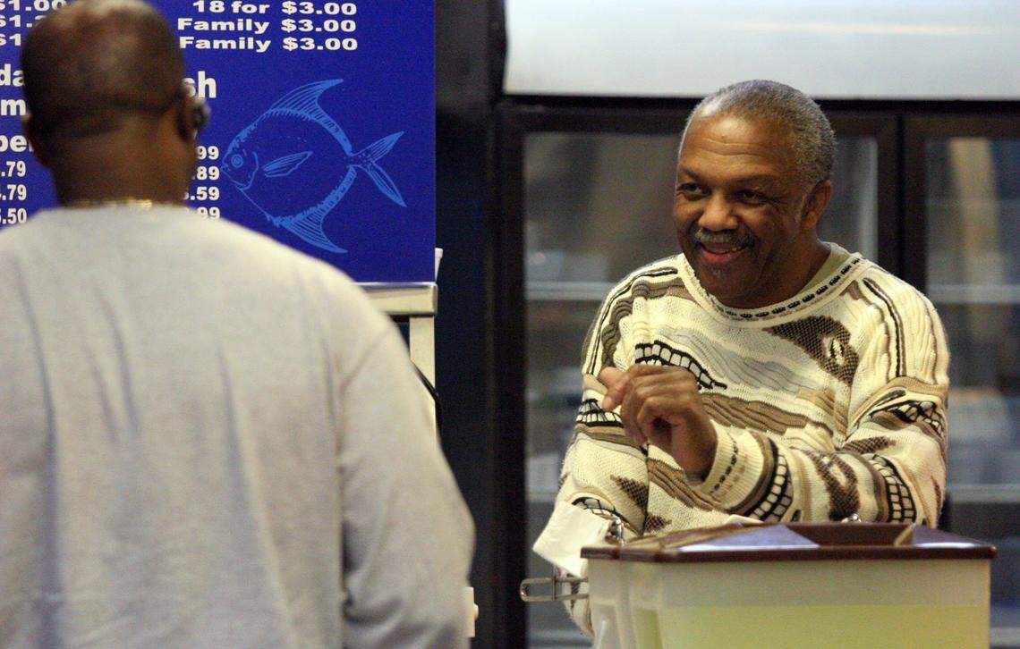 Palmetto Seafood Co. owner Lucius Moultrie talks with customer Mike Crawford whohe has known for over 25 years after filling his order.