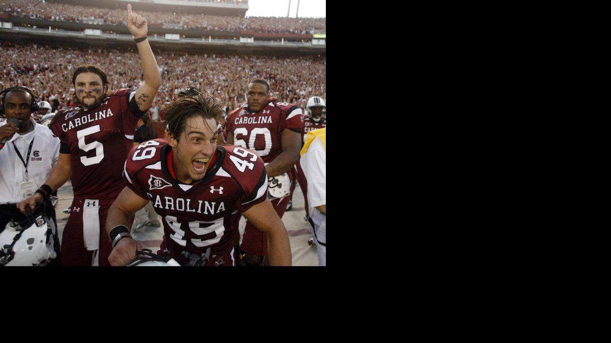 USC's Stephen Garcia (5) and Blake Baxley (49), celebrate the Gamecocks' win against top-ranked Alabama in 2010.
