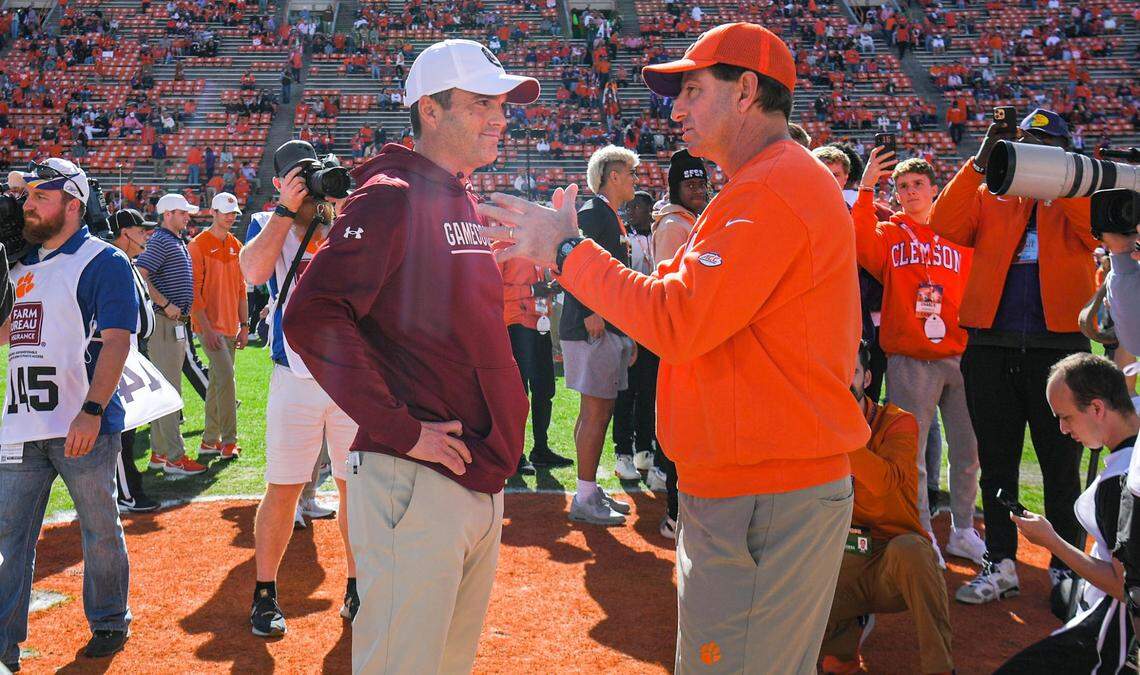 Nov 26, 2022; Clemson, SC, USA; Clemson head coach Dabo Swinney, right, and South Carolina head coach Shane Beamer talk before the game at Memorial Stadium in Clemson, S.C. Saturday, Nov. 26, 2022.