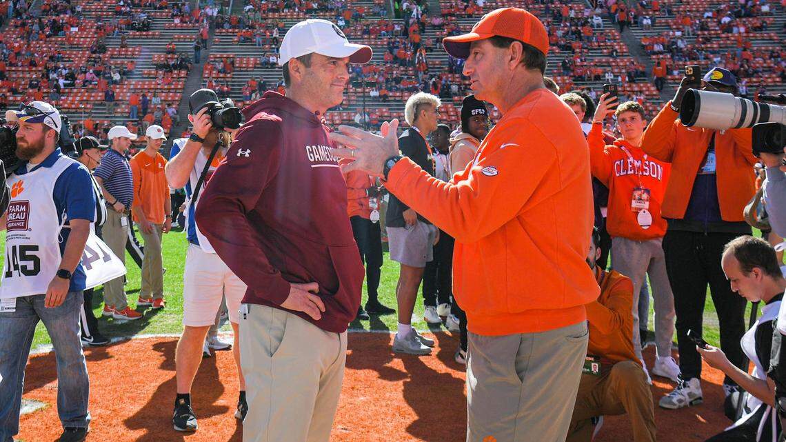 Nov 26, 2022; Clemson, SC, USA; Clemson head coach Dabo Swinney, right, and South Carolina head coach Shane Beamer talk before the game at Memorial Stadium in Clemson, S.C. Saturday, Nov. 26, 2022.