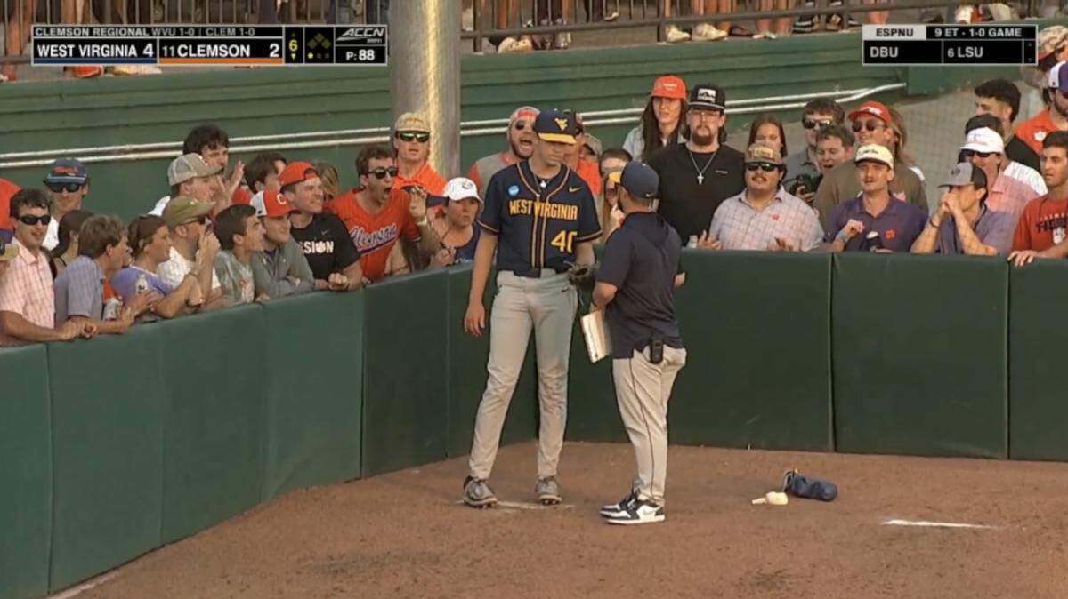 Clemson fans yell toward West Virginia pitcher Carson Estridge (40) while he warms up in the visitors’ bullpen at Doug Kingsmore Stadium during a May 31 NCAA baseball regional game.