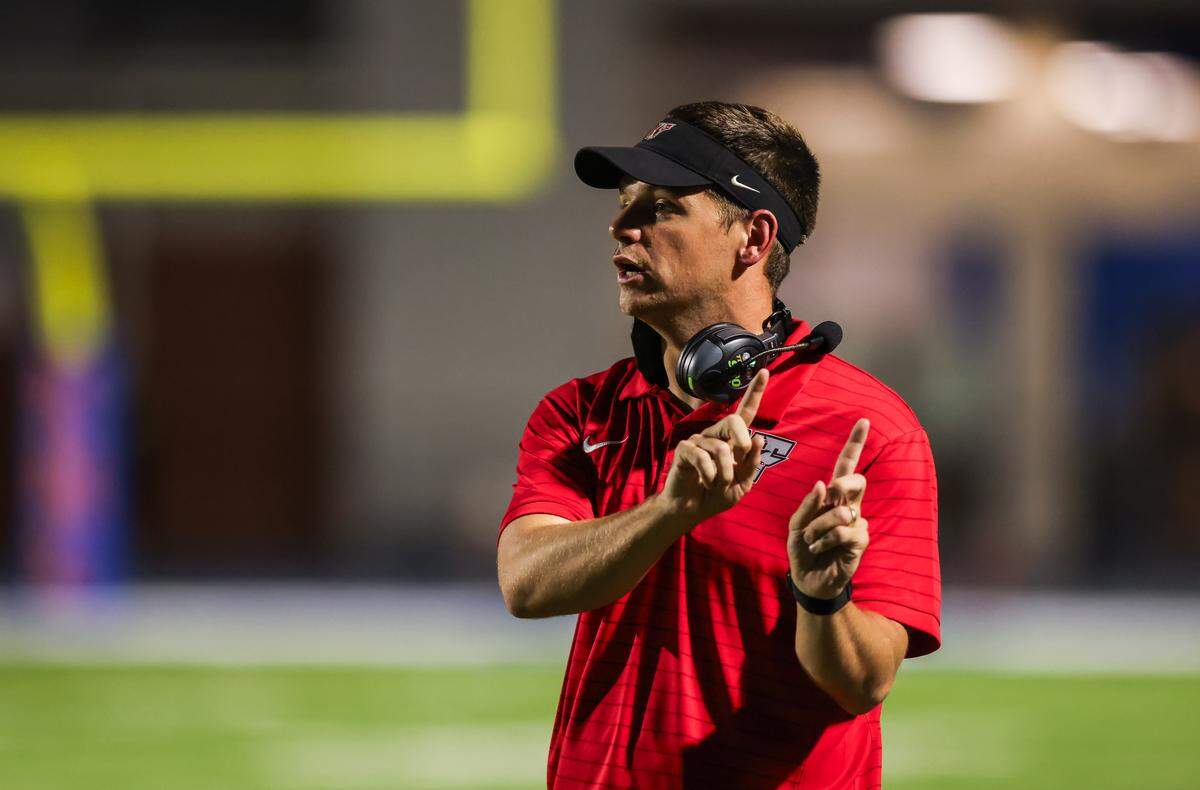 Nation Ford head coach Jake Bentley speaks with his players during their game against Richland Northeast.