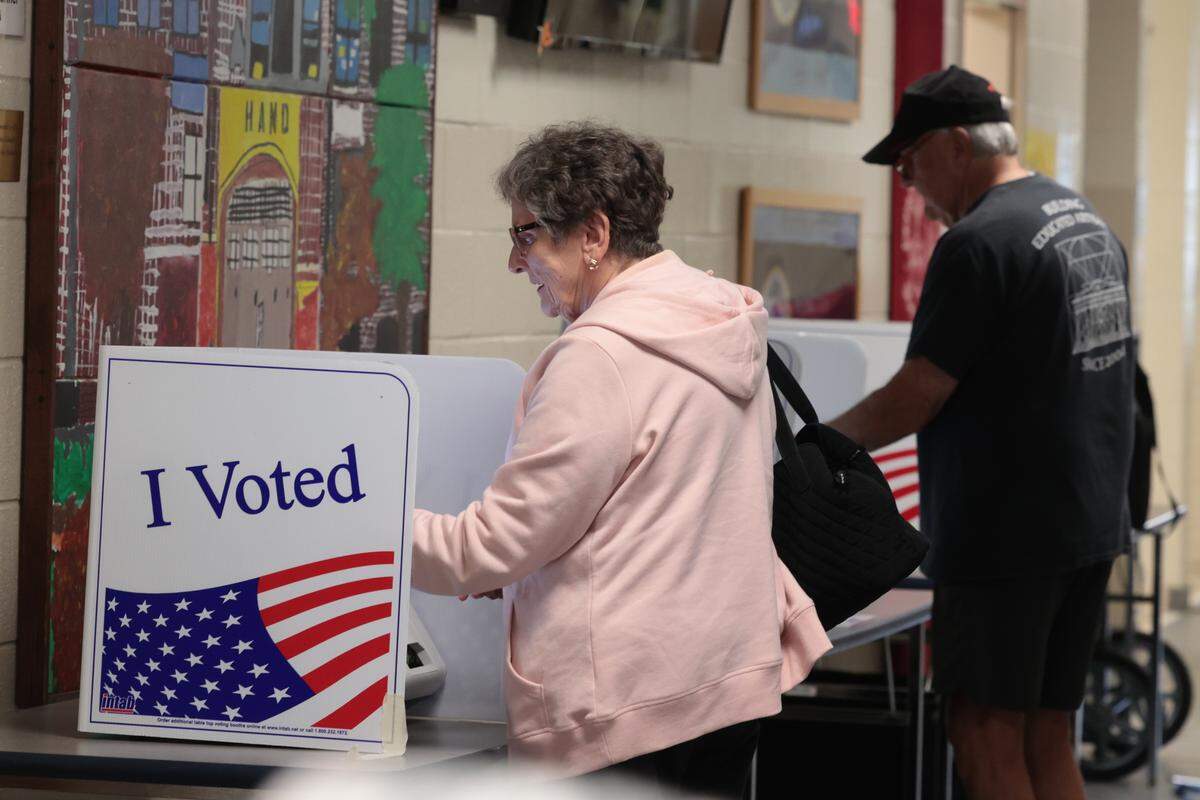 Becky Sutusky and Michael Boozer cast their ballots in the municipal election at Hand Middle School on Tuesday, Nov. 4, 2025.