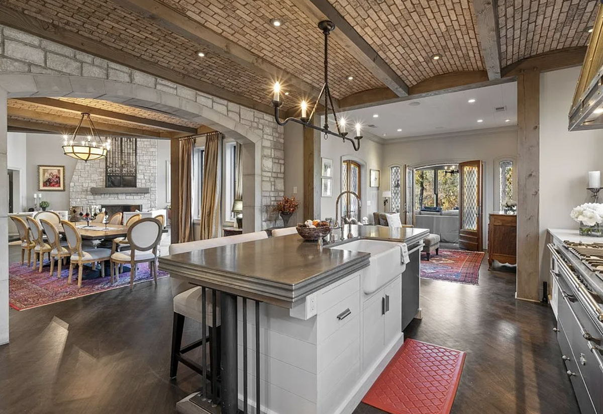 The kitchen has Carrara marble countertops, a zinc range hood, and a Lacanche steel and nickel range with multiple ovens.