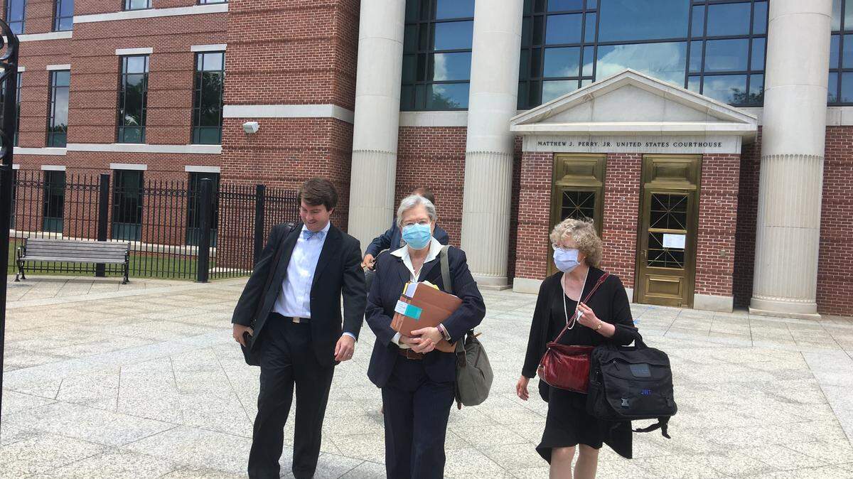 State Election Commission lawyers (from left) Grayson Lambert, Liz Crum and Jane Trinkley leave federal court in Columbia Friday. Under court rules, they were required to wear masks during an absentee ballot hearing.
