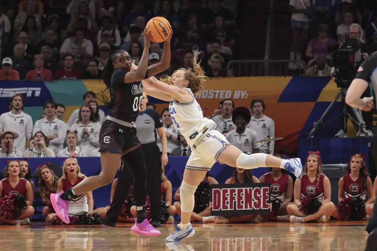South Carolina's Ta'Niya Latson (00) nabs a pass intended for UCLA’s Gianna Kneepkens (8) during the first half of action of their women's basketball game for the NCAA national championship against UCLA at Mortgage Matchup Center in Phoenix on Sunday, April 5,2026.