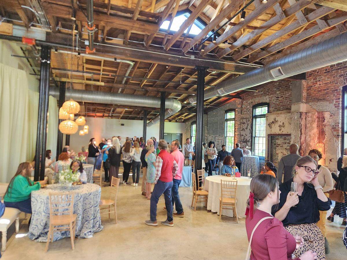 People gather on April 9, 2025 at the grand opening of The Laundry, a new event space venue in the BullStreet District.