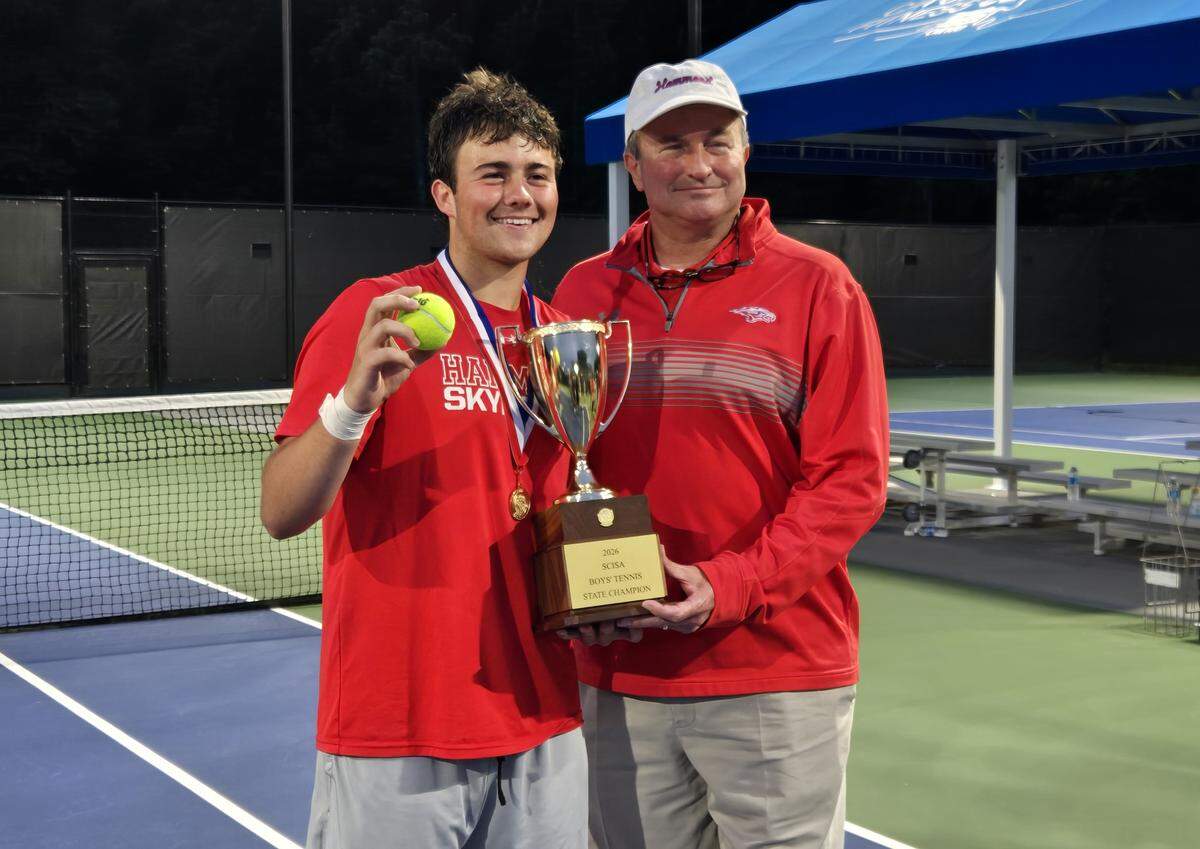 Hammond tennis player William Gillespie, left, and his father, Trent Gillespie, celebrate as the Skyhawks won the 2026 SCISA boys tennis championship on May 1, 2026 at the Cayce Tennis Center.