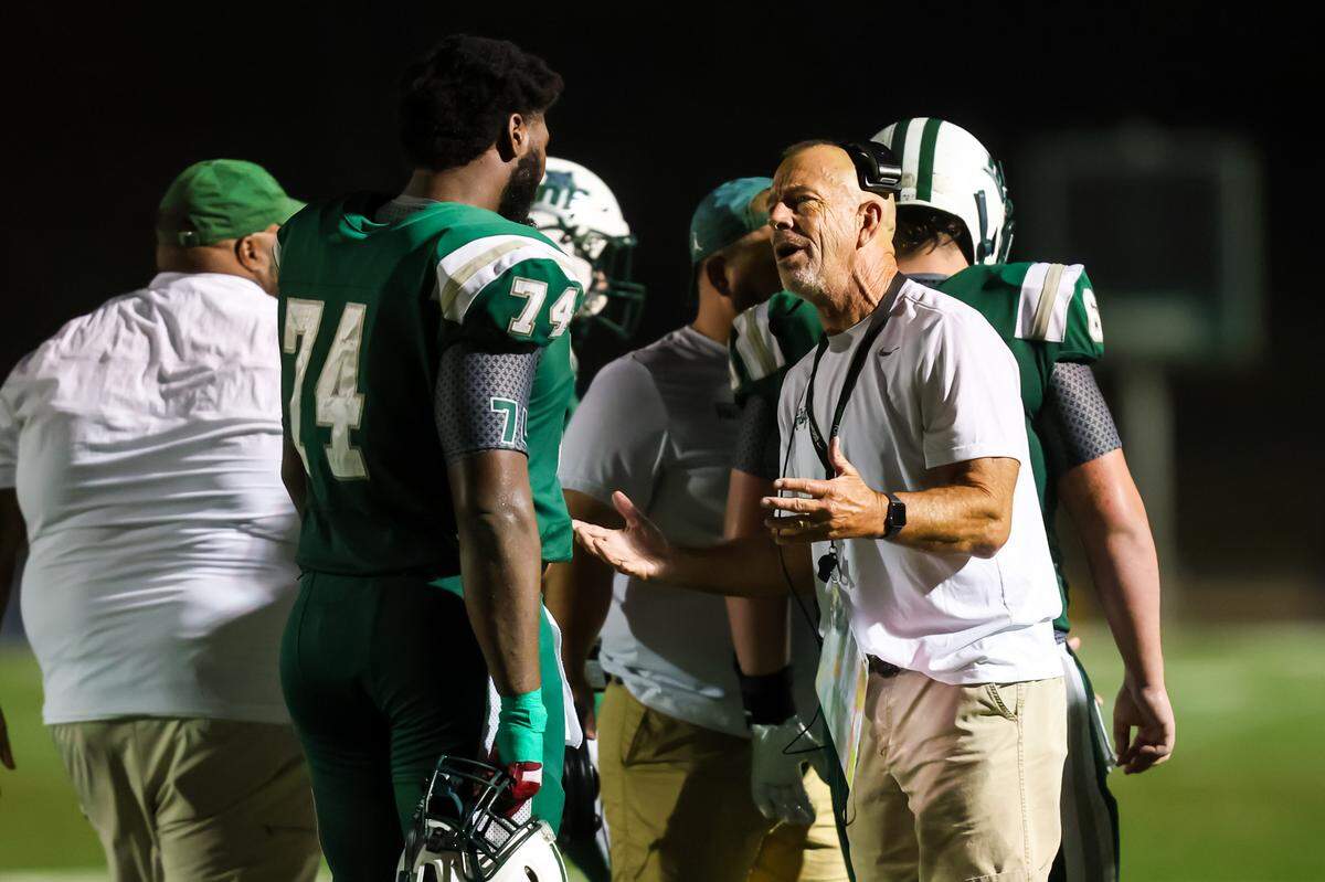 Dutch Fork Silver Foxes head coach Tom Knotts directs offensive lineman Josh Benson (74) during their game at Dutch Fork High School, 11/8/24.