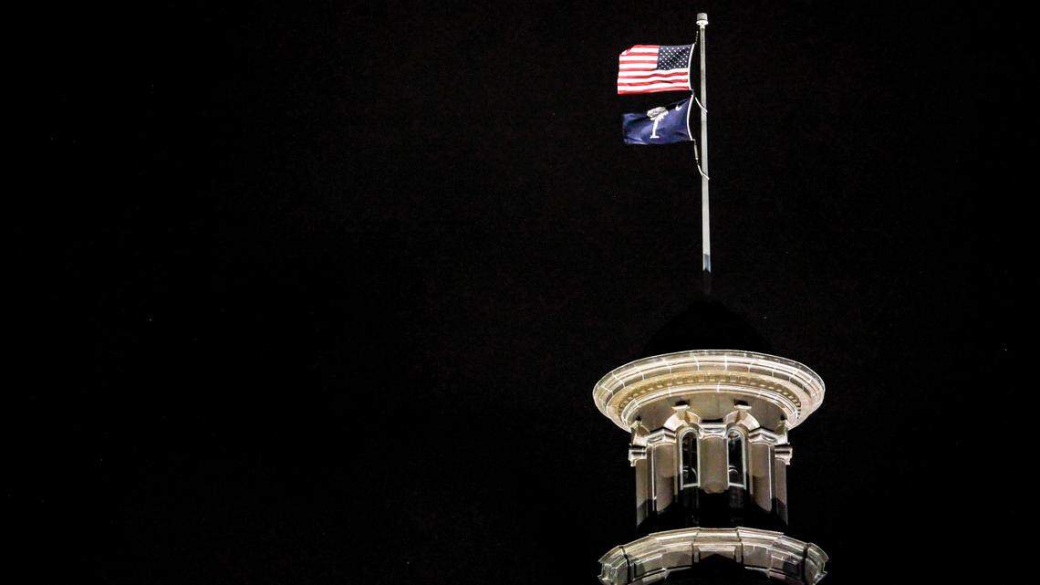 The exterior dome of the South Carolina statehouse is seen at night as flags fly in downtown Columbia, S.C. on Monday, March 7, 2022.