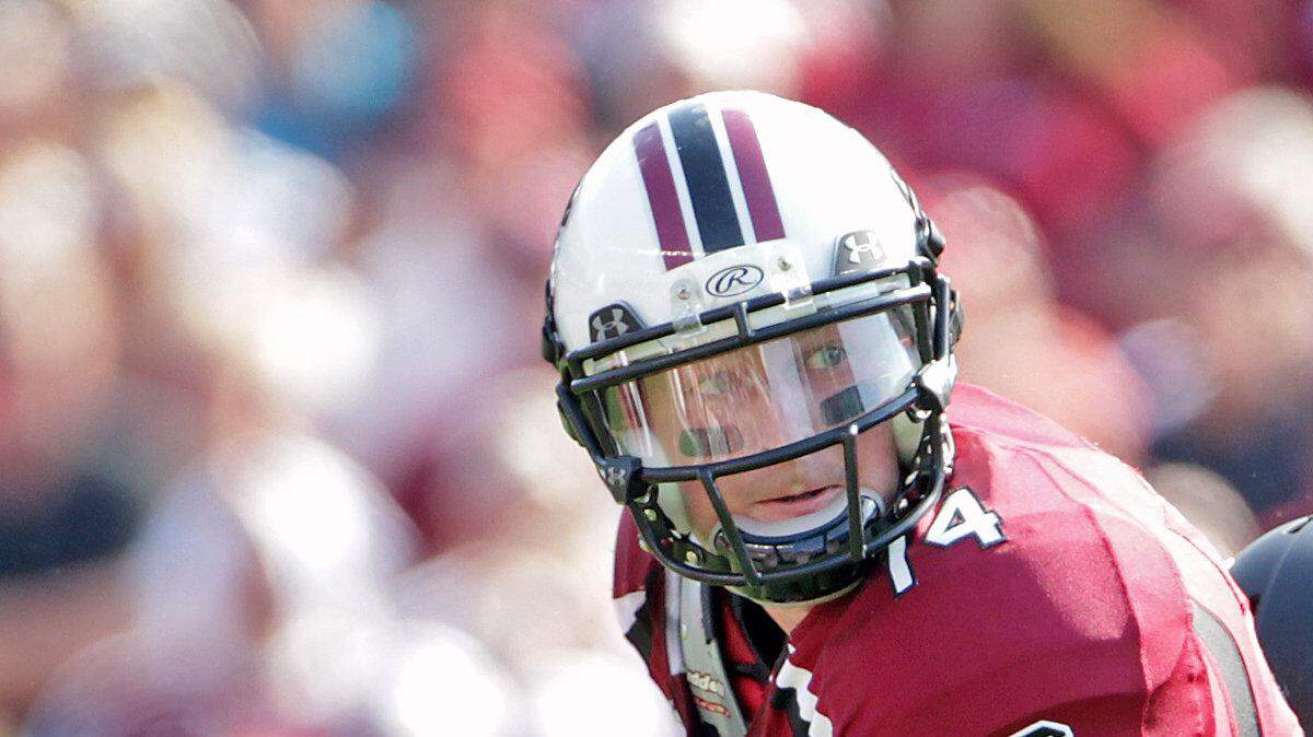 University of South Carolina quarterback, Connor Shaw,  looks to make a pass as he is pursued by Missouri's Andrew Wilson in the second quarter at William-Brice Stadium in Columbia, S.C. Shaw made a pass to Justice Cunningham for a first down.