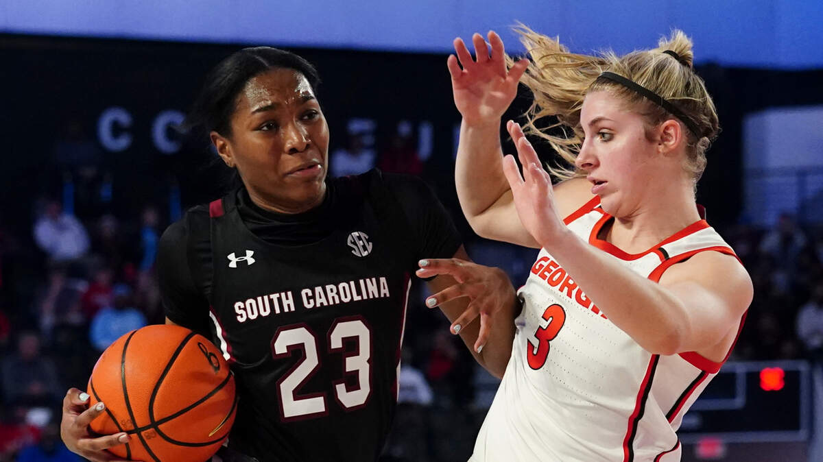 South Carolina guard Bree Hall (23) drives against Georgia guard Sarah Ashlee Barker (3) during the first half of an NCAA college basketball game Sunday, Feb. 13, 2022, in Athens, Ga. (AP Photo/John Bazemore)