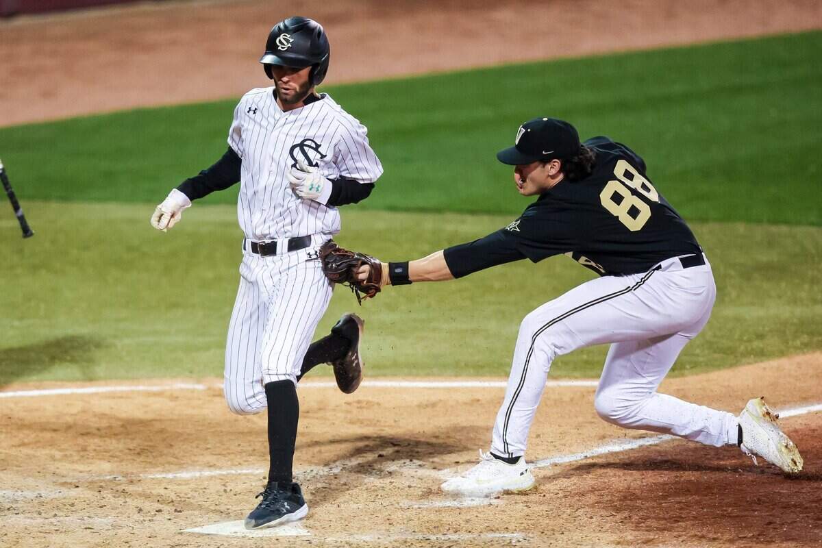 South Carolina Gamecocks infielder Brandt Belk (13) scores on a wild pitch as Vanderbilt Commodores pitcher Patrick Reilly (88) applies a late tag during their game at Founders Park Friday, March 25, 2022. Belk was first called out, but the play was overturned via replay.