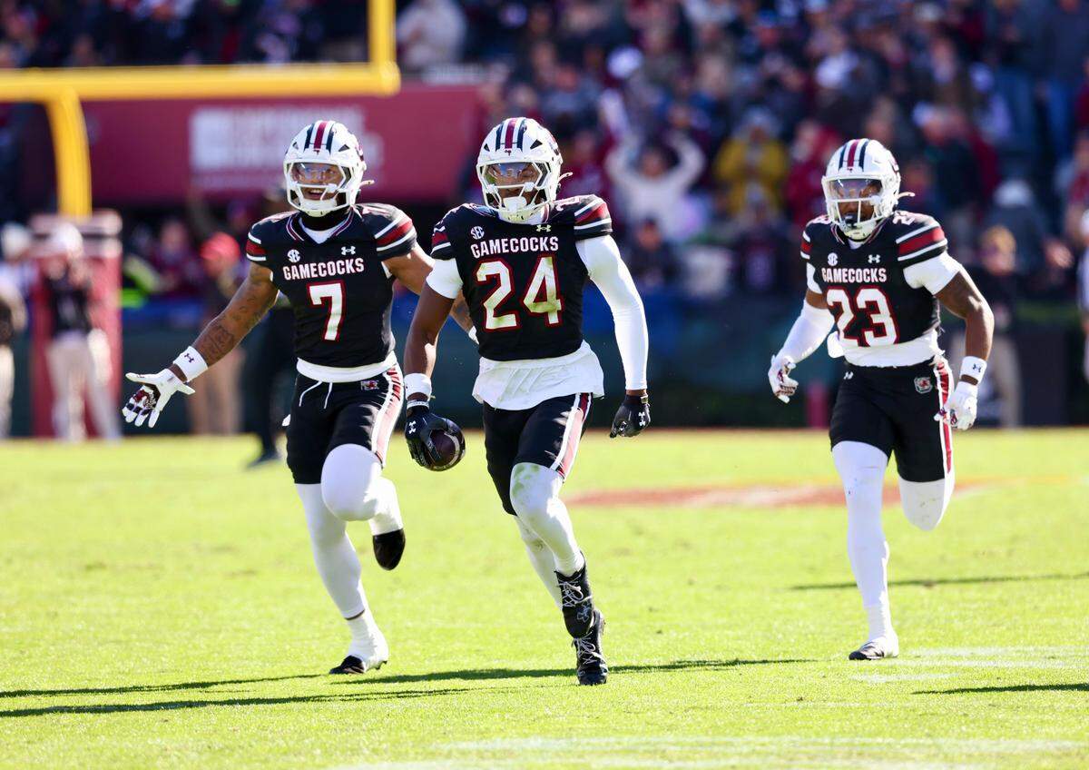 South Carolina's Jalon Kilgore (24) and teammates celebrate his interception Saturday against Clemson at Williams-Brice Stadium.