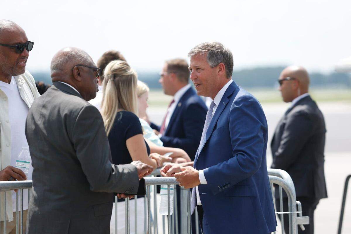 Rep. James Clyburn and Columbia Mayor Daniel Rickenmann chat outside the Columbia Metropolitan Airport before President Joe Biden’s arrival Thursday.