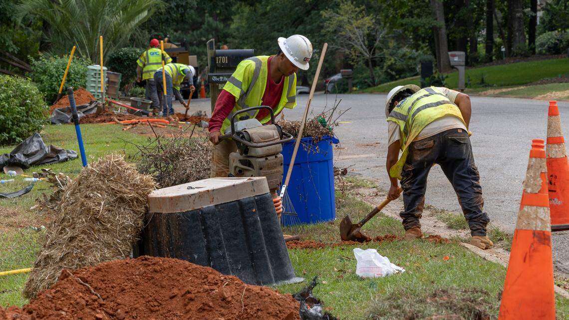 Workers with GAC Enterprises, LLC., dig along Willow Creek Drive in Irmo to place conduit for fiberoptic cable.