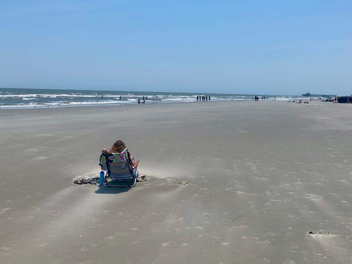A woman reads a book at Folly Beach on Monday, May 24. Along with its 8 miles of oceanfront, Folly Beach is also the closest beach to historic downtown Charleston.
