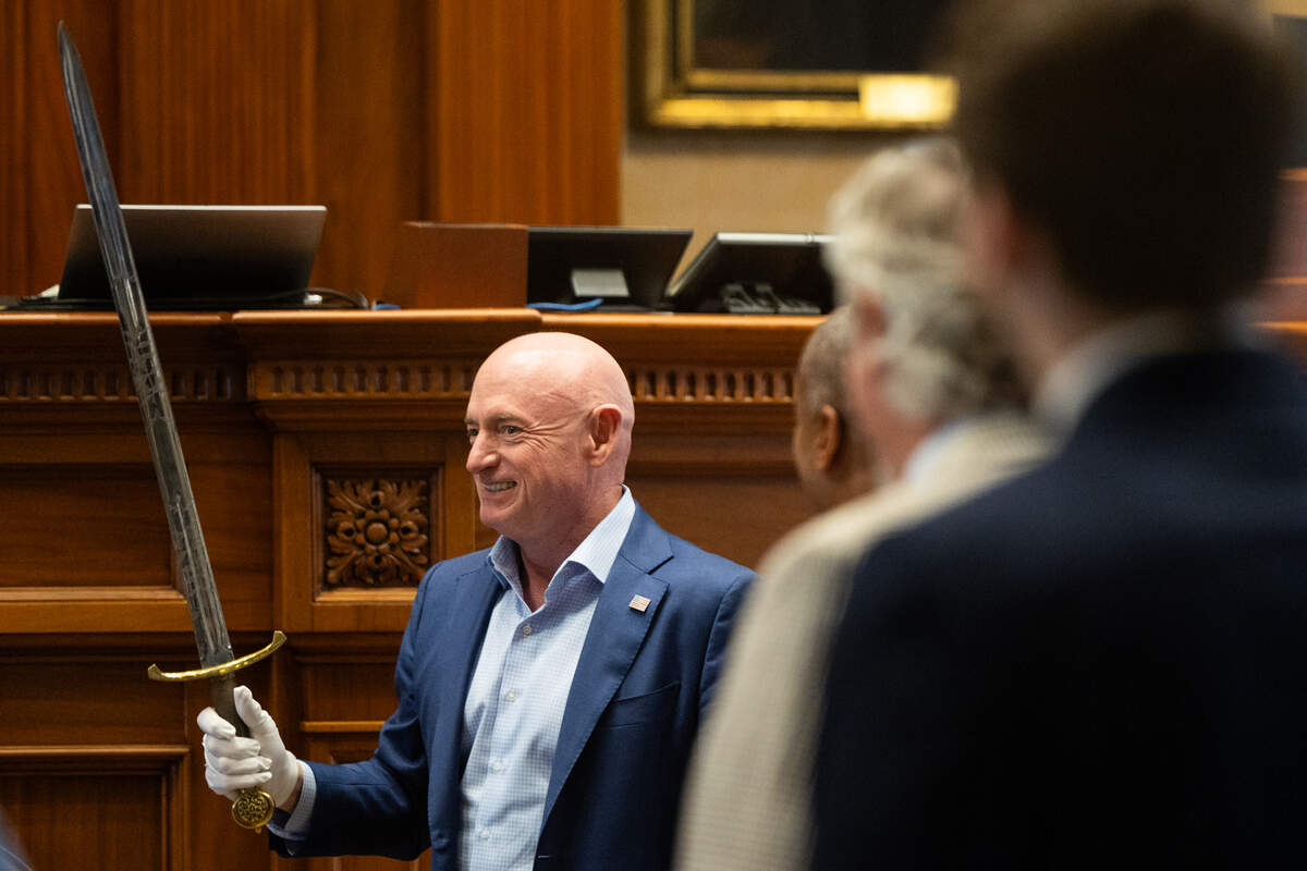 Senator Mark Kelly holds the Sword of State of South Carolina during a visit to support House Democrats on Friday, May 15, 2026. The sword a symbol of the South Carolina Senate, with history dating back to the founding of the Carolina colony.