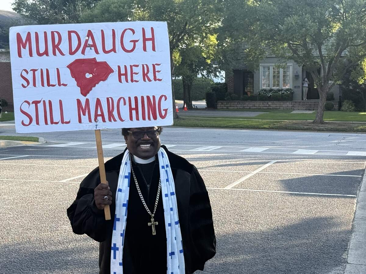 Pastor at Mount Pisgah Baptist Church, the Rev. Raymond Johnson, carries a sign outside disgraced Lowcountry lawyer Alex Murdaugh’s status hearing Monday. Johnson has been a regular fixture in the legal frenzy surrounding Murdaugh, since he was indicted for murder in 2022.
