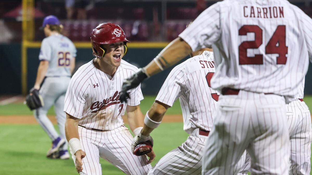 South Carolina outfielder Dalton Mashore (3) celebrates with teammates after scoring the winning run on a wild pitch during the Gamecocks’ game against LSU at Founders Park in Columbia on Thursday, May 15, 2025.