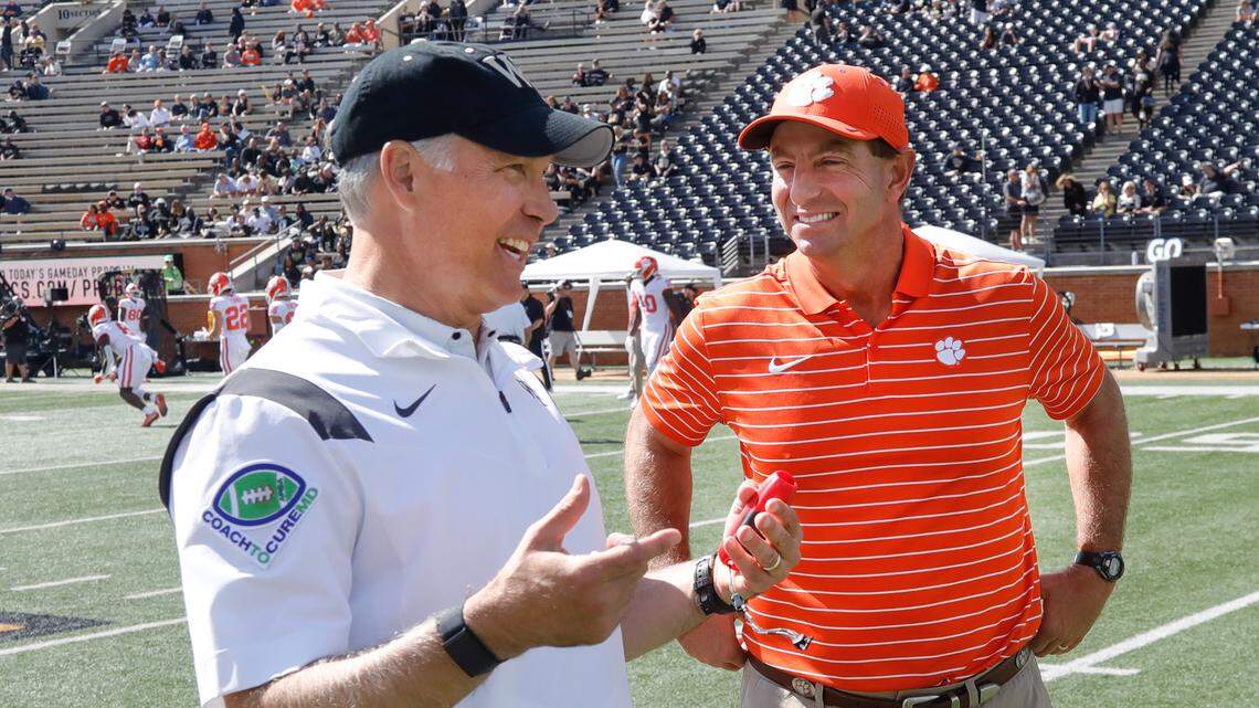 Sep 24, 2022; Winston-Salem, North Carolina, USA; Wake Forest Demon Deacons head coach Dave Clawson (left) and Clemson Tigers head coach Dabo Swinney talk at mid field before the game at Truist Field.
