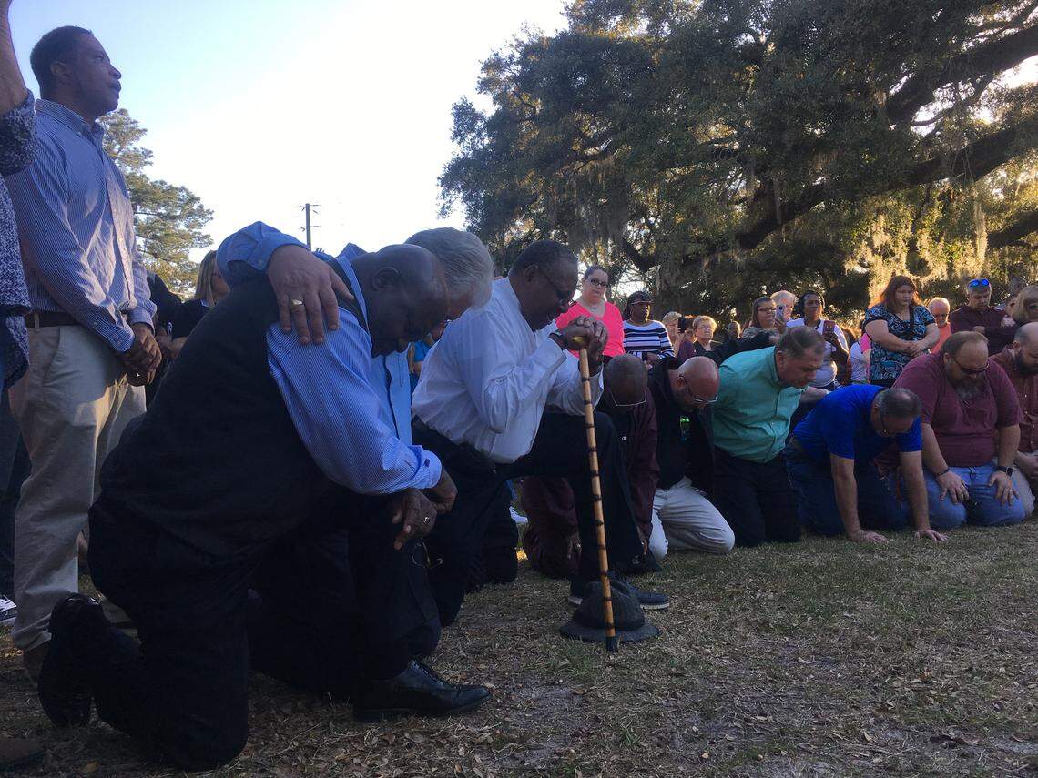 Pastors and residents of Walterboro pray on their knees at a vigil after the death of Raniya Wright.