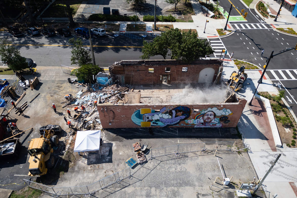 The Hunter-Gatherer location on South Main Street in Columbia, South Carolina is deconstructed on Saturday, June 28, 2025. Teams of volunteers assisted organizing pieces of the building for resale, and helped to preserve the mural of Aaron Graves, a local musician who died of cancer in 2019.
