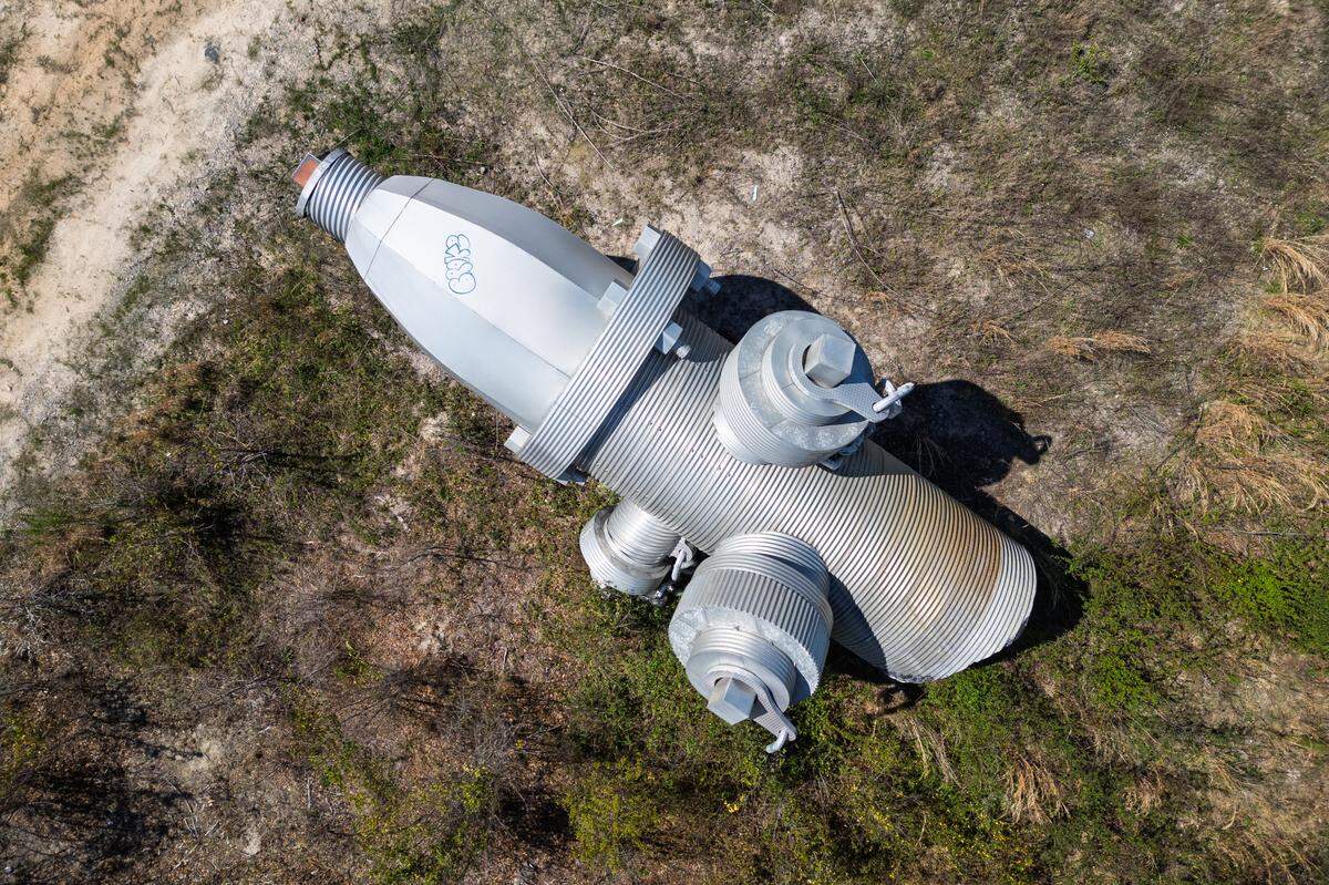 Busted Plug, a sculpture by Columbia artist Blue Sky, lays in a field north of Columbia on Wednesday, March 26, 2025. The 40-foot sculpture was installed in downtown Columbia until 2023.