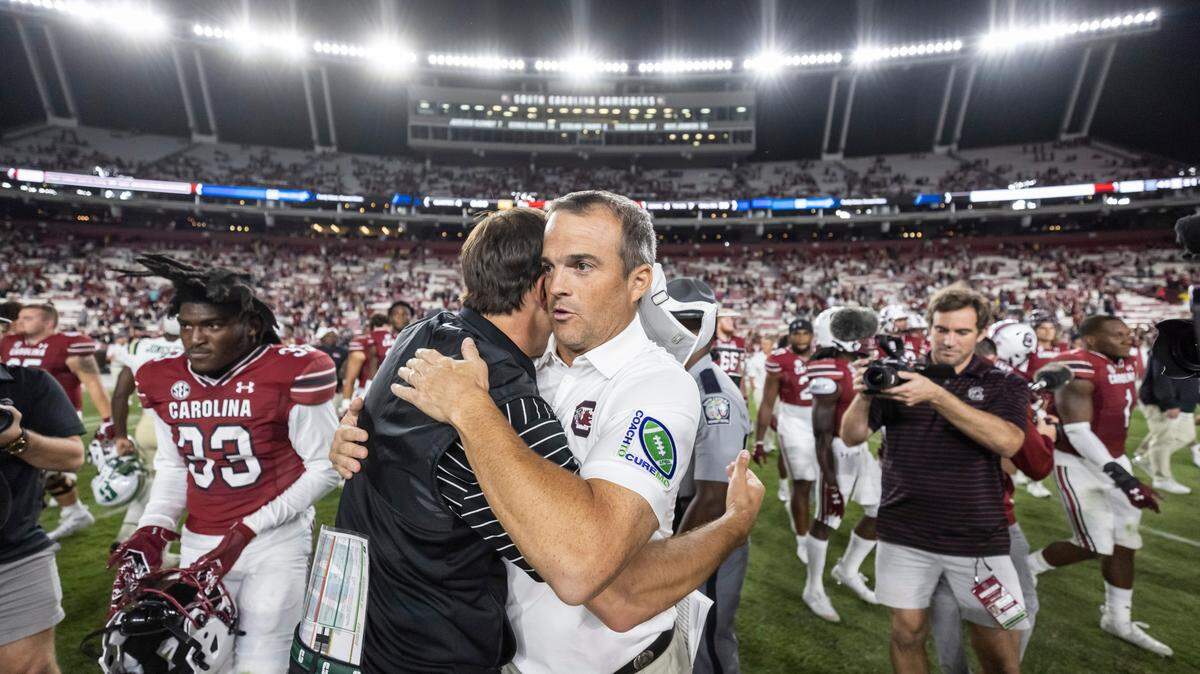 South Carolina head coach Shane Beamer speaks with head coach Will Healy of the University of North Carolina at Charlotte after the Gamecocks’ win at Williams-Brice Stadium in Columbia, SC on Saturday, Sept. 24, 2022.
