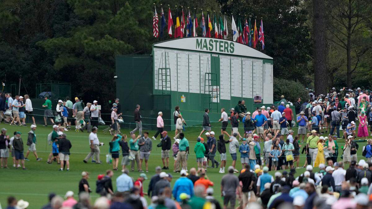 Spectators leave Augusta National Golf Course after a weather warning was issued during a practice round at the Masters golf tournament on Wednesday, April 6, 2022, in Augusta, Ga. (AP Photo/Matt Slocum)