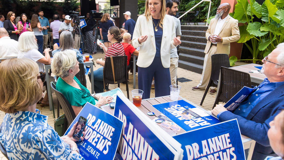 Senate candidate Dr. Annie Andrews speaks with supporters during an event for her at Bourbon Main Street in downtown