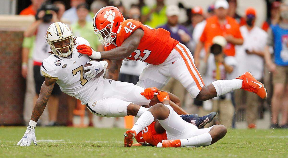 Clemson linebacker LaVonta Bentley (42) takes down Georgia Tech wide receiver Malachi Carter (7) during second-quarter action in Clemson, S.C. on Saturday, Sept. 18, 2021.
