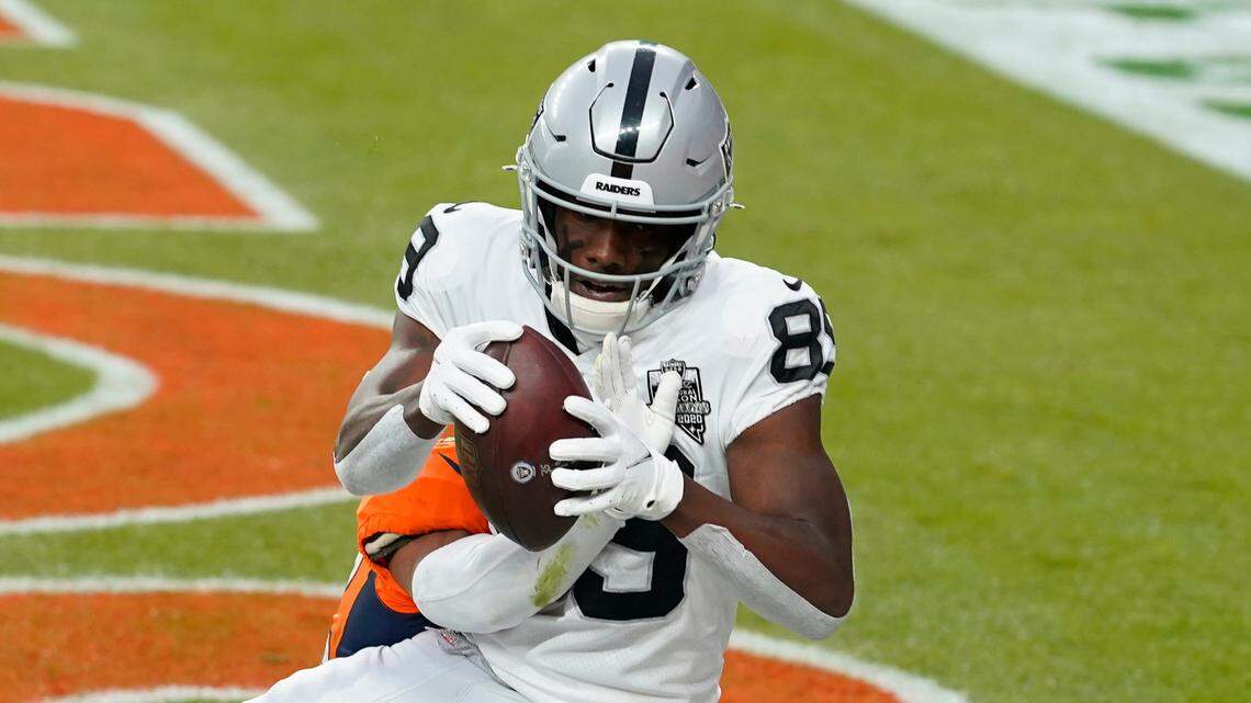 Las Vegas Raiders wide receiver Bryan Edwards (89) catches a pass for a touchdown over Denver Broncos cornerback Parnell Motley during the first half of an NFL football game, Sunday, Jan. 3, 2021, in Denver. (AP Photo/David Zalubowski)