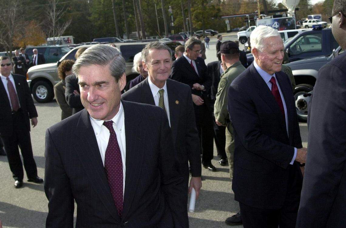 FBI Director Robert Mueller, front, visits SLED facilities with Senator Ernest “Fritz” Hollings Jr., right, after the unveiling cremony of the S.C. Computer Crime Center Tuesday. Leading the tour is SLED Chief Robert Stewart, middle. 12/17/02 Takaaki Iwabu