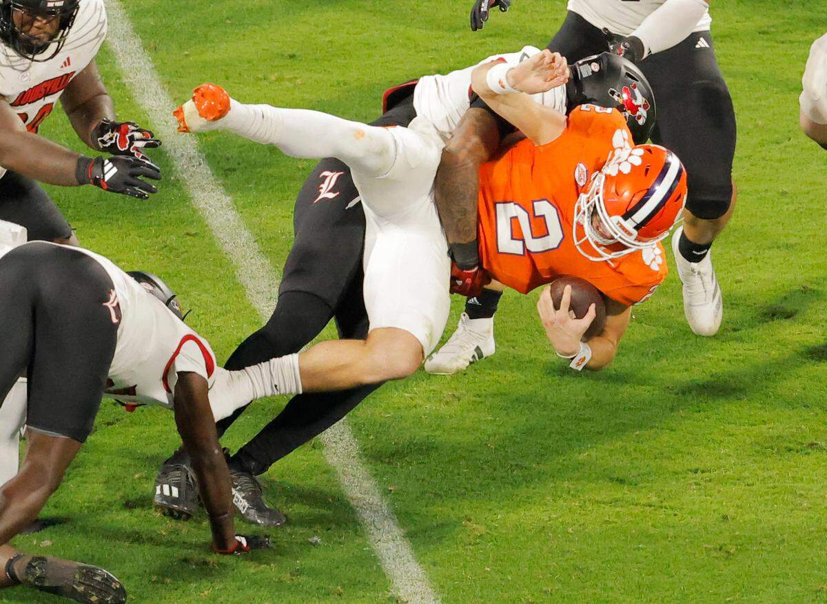 Clemson quarterback Cade Klubnik (2) is slammed to the ground by Louisville during first-half action in Clemson, S.C. on Saturday, Nov. 2, 2024.