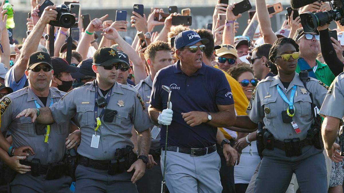 Phil Mickelson wades through fans on the 18th fairway during the final round at the PGA Championship golf tournament on the Ocean Course, Sunday, May 23, 2021, in Kiawah Island, S.C. (AP Photo/Matt York)