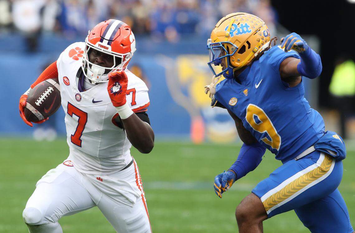Clemson Tigers running back Phil Mafah (7) runs the ball against Pittsburgh Panthers linebacker Kyle Louis (9) during the first quarter at Acrisure Stadium.