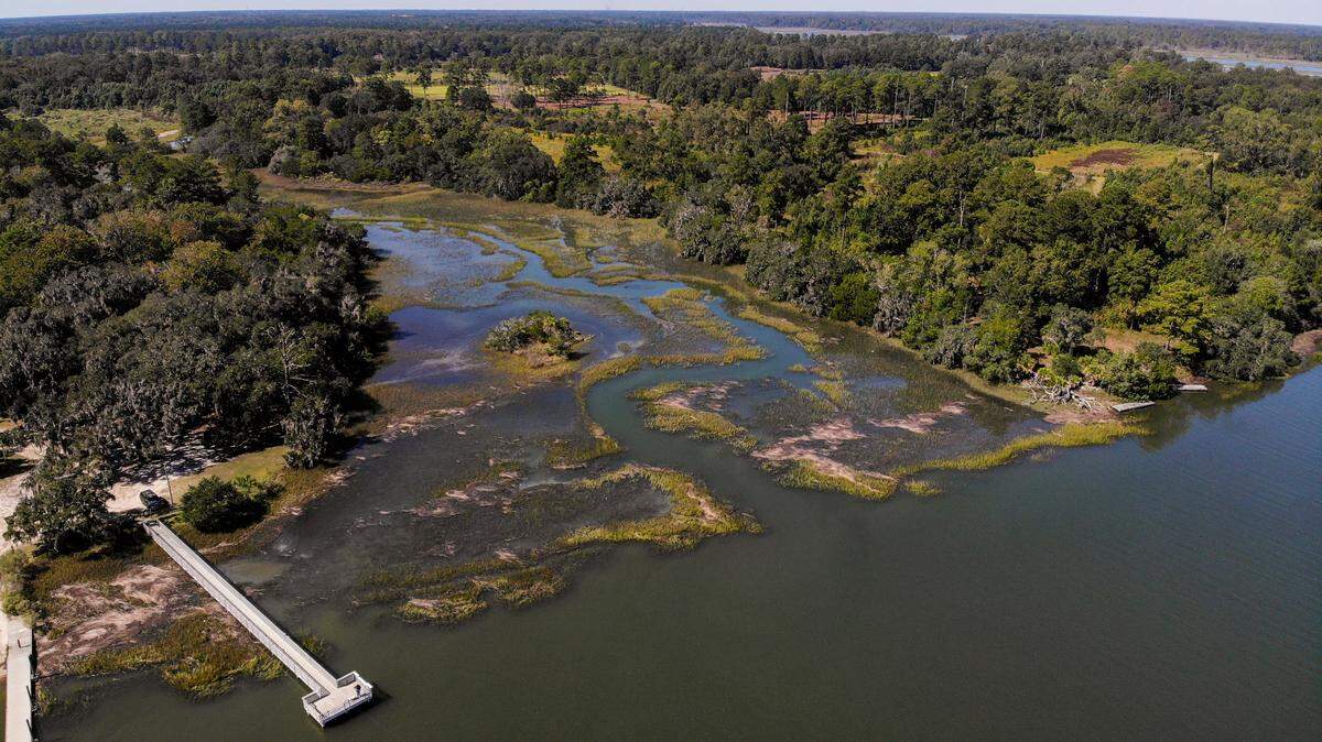A person fishes from the pier at the Bolan Hall Landing in the Euhaw Creek on Friday, Oct. 14, 2022 in Jasper County. The lush grounds of Tickton Hall, sandwiched between Bolan Hall Road and Euhaw Creek to its north are under contract to be sold and is likely to be developed.