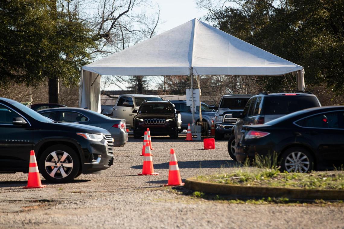 Dozens of people wait in their cars for coronavirus tests and vaccines at the Department of Health and Environmental Control on Tuesday, January 4, 2022.