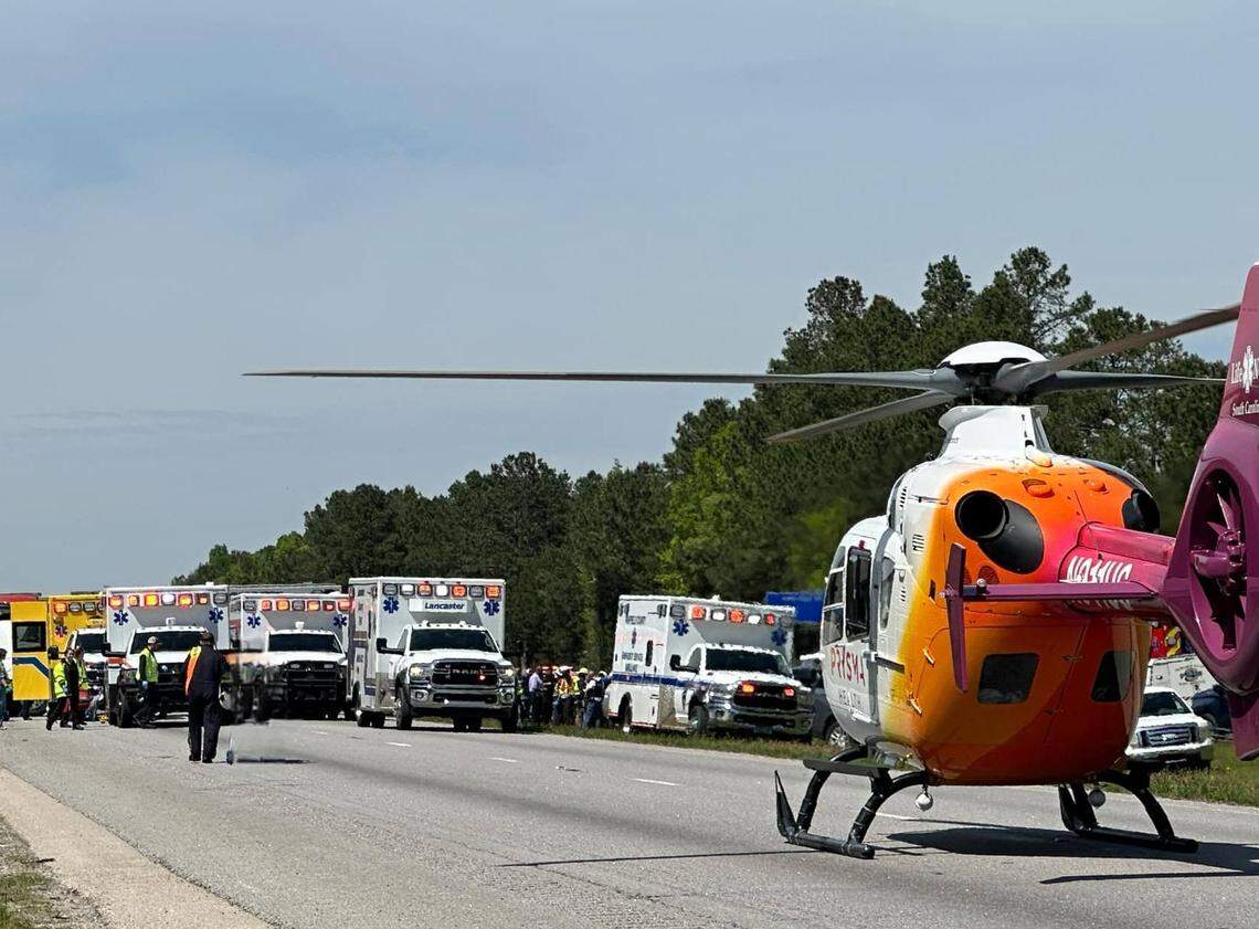 Emergency service personnel including a medical helicopter line Interstate 77 to render aid after a school bus carrying students from Pine Ridge Middle School overturned.