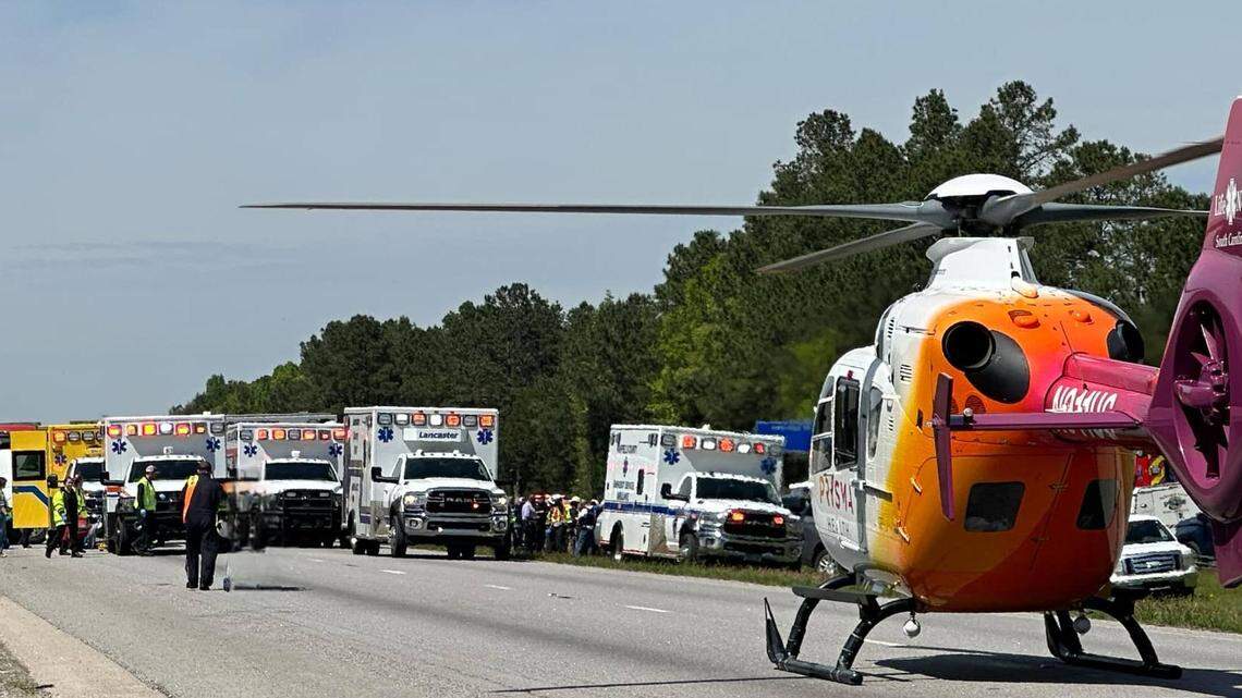 Emergency service personnel including a medical helicopter line Interstate 77 to render aid after a school bus carrying students from Pine Ridge Middle School overturned.