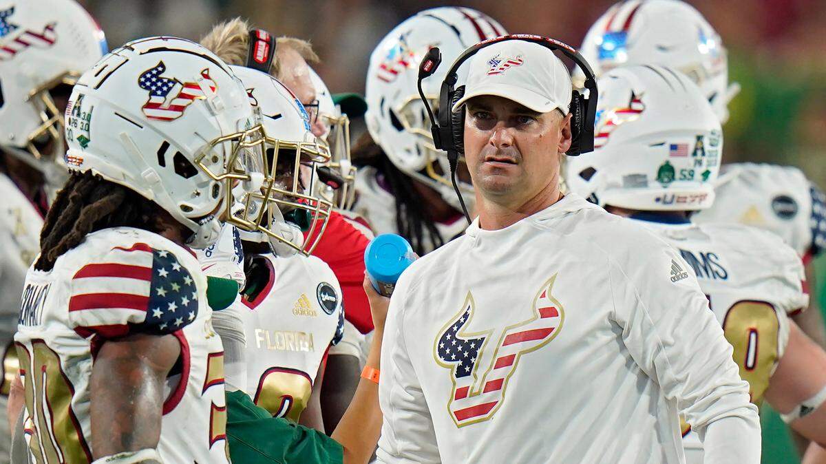 South Florida head coach Jeff Scott talks to his team during the second half of an NCAA college football game against Cincinnati Friday, Nov. 12, 2021, in Tampa, Fla. (AP Photo/Chris O’Meara)