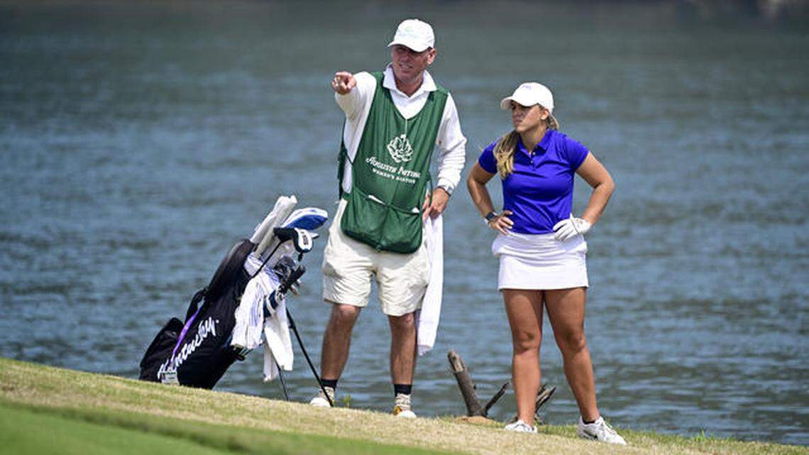Jensen Castle of the United States talks with caddie Kemp Hooper on the No. 4 hole during round one of the Augusta National Women’s Amateur at Champions Retreat Golf Club, Wednesday, March 30, 2022.