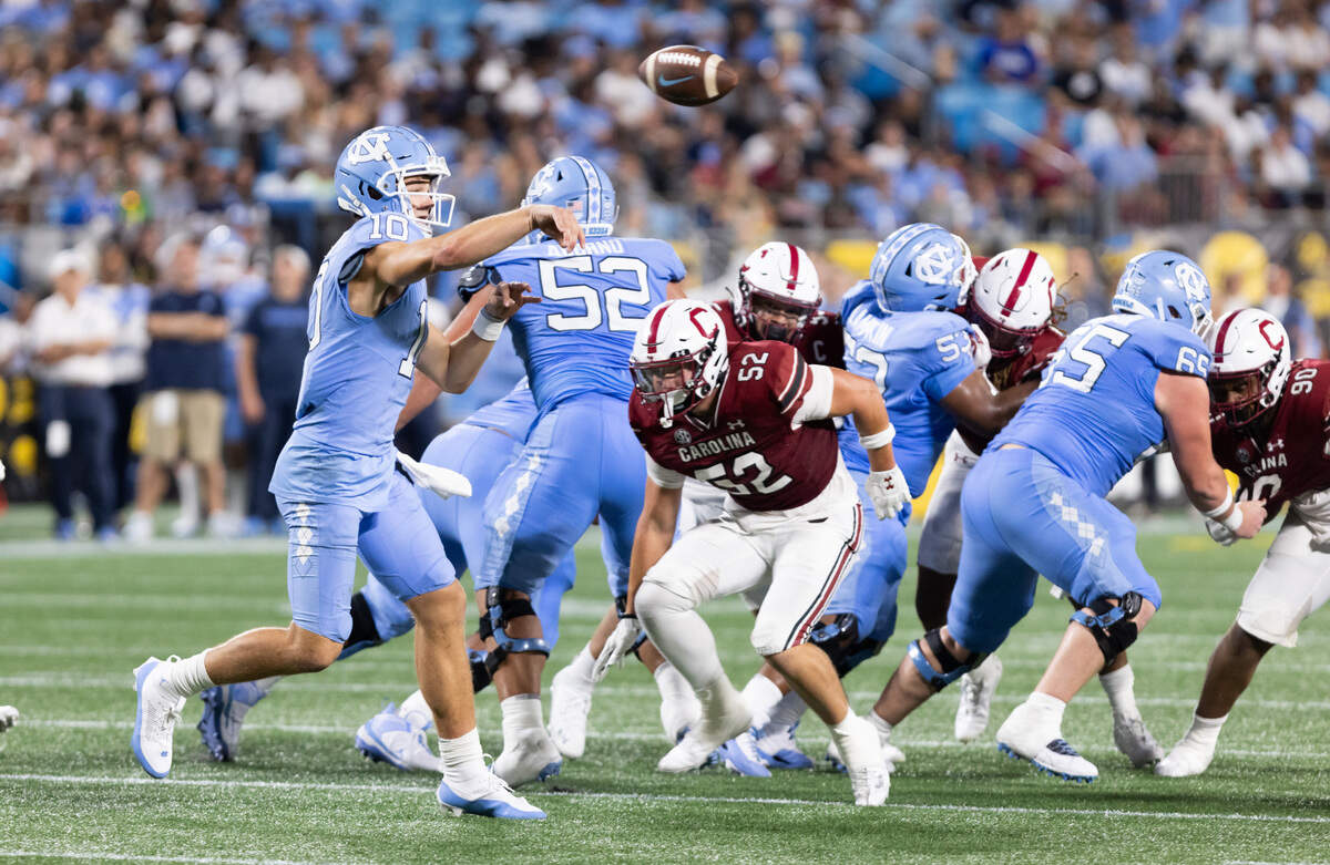 North Carolina quarterback Drake Maye (10) makes a pass as South Carolina linebacker Stone Blanton (52) pressures during the Gamecocks’ season opener against North Carolina at Bank of America Stadium in Charlotte on Saturday, September 2, 2023.