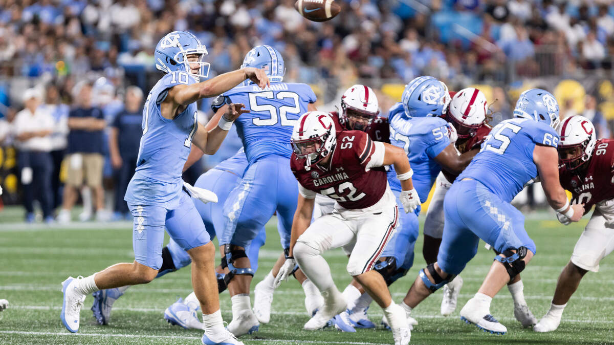 North Carolina quarterback Drake Maye (10) makes a pass as South Carolina linebacker Stone Blanton (52) pressures during the Gamecocks’ season opener against North Carolina at Bank of America Stadium in Charlotte on Saturday, September 2, 2023.