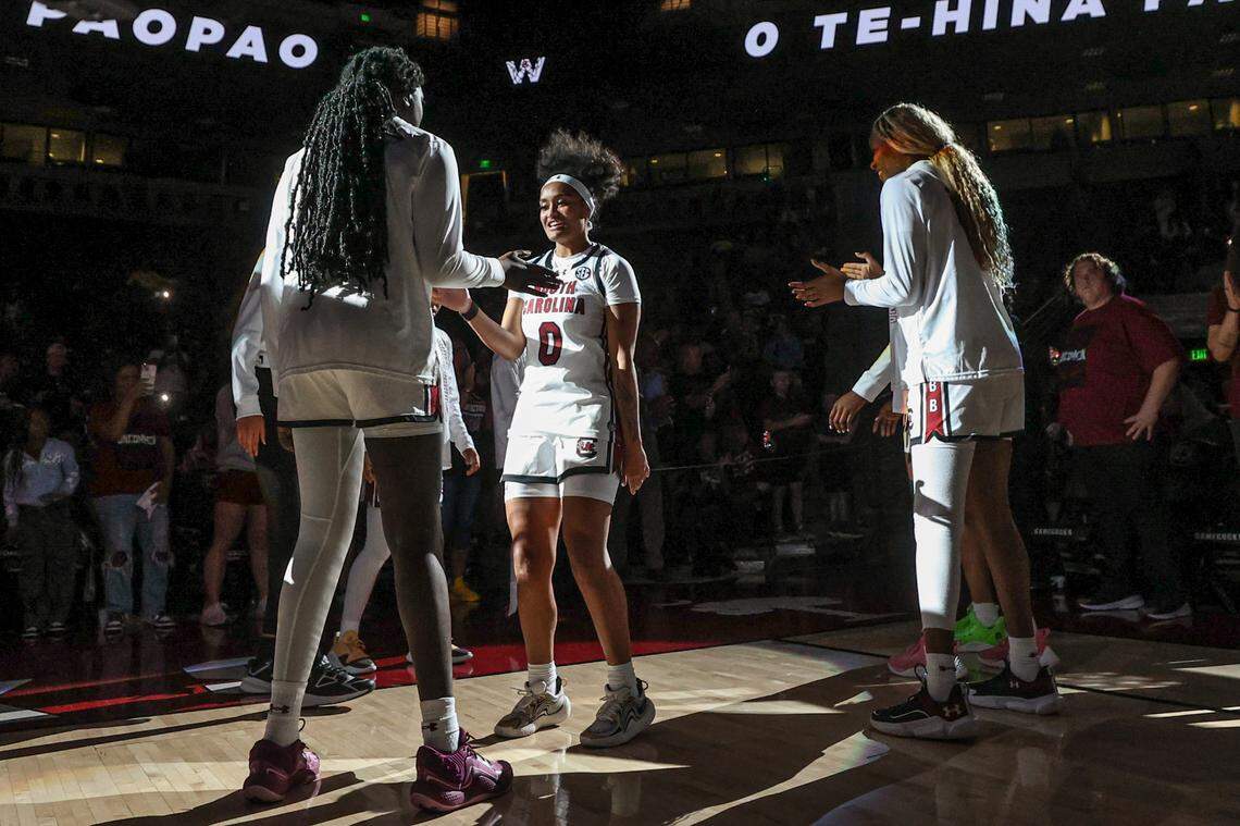 University of South Carolina’s Adhel Tac (15) and University of South Carolina’s Te-Hina Paopao (0) do a hand-clap routine during team introductions in the Colonial Life Arena on Monday, Oct. 28, 2024.